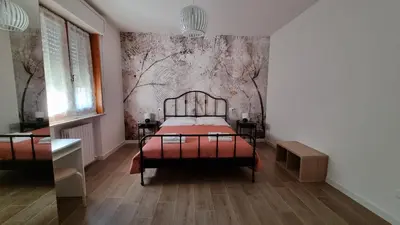 Letto o letti in una camera di B&B Via Guareschi