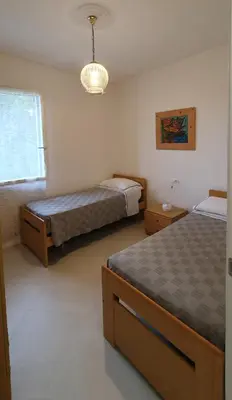 Letto o letti in una camera di casa nel verde della Val di Vara