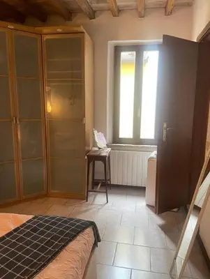 Letto o letti in una camera di CasaFiore Art Bijoux in centro storico a Parma
