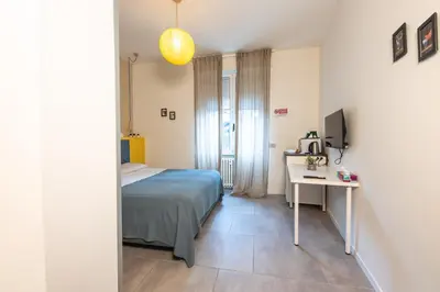 Letto o letti in una camera di Guesthouse Margherita di Parma