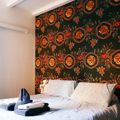 Letto o letti in una camera di URBAN JUNGLE TORTELLINOSUITE Modena