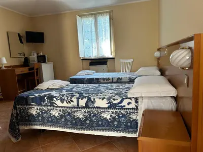 Letto o letti in una camera di INOSTERIA Affittacamere