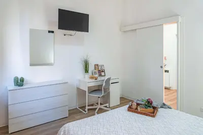 Letto o letti in una camera di Casa Golgi - Pavia City - by Host4U