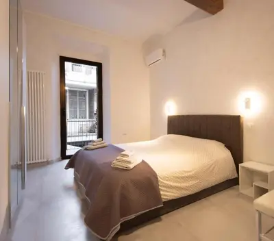 Letto o letti in una camera di Via Verdi SUITE