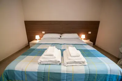 Letto o letti in una camera di Porta Galileo l Comfort Rooms & Parking