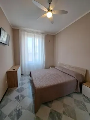 Letto o letti in una camera di APPARTAMENTO ESTHER Levanto