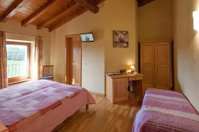Letto o letti in una camera di Hotel Alla Corte dei Bicchi