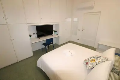 Letto o letti in una camera di Appartamento al Duomo di Parma - posto auto privato prenotabile