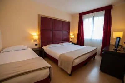 Letto o letti in una camera di ALBA HOTEL
