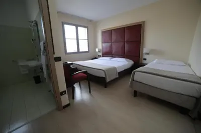 Letto o letti in una camera di ALBA HOTEL