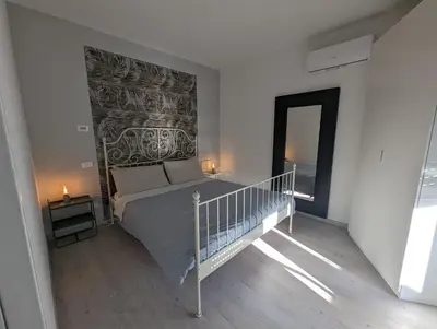 Letto o letti in una camera di Appartamento con terrazzo