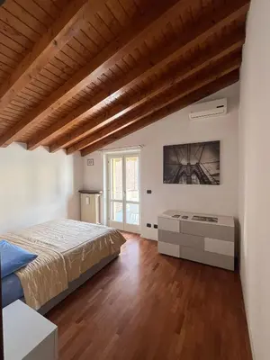 Letto o letti in una camera di Terrazza su Volta Mantovana