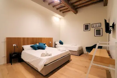 Letto o letti in una camera di Accademia Suite Modena il tuo soggiorno nel Centro Storico di Modena