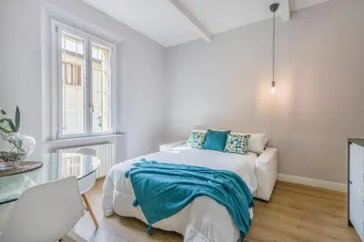 Letto o letti in una camera di ViaEmilia 2 min dal centro, 4 Persone, WIFI, Aria condizionata