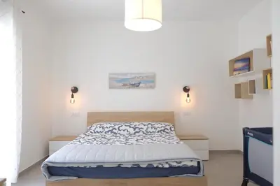 Letto o letti in una camera di Riva Ponente