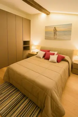 Letto o letti in una camera di WELCOME RIVIERA- Mazzini 77 con WIFI, condizionamento in ogni stanza, parcheggio a pagamento 15euro al giorno da prenotare in anticipo