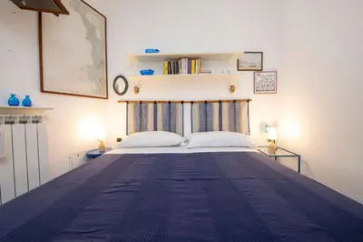 Letto o letti in una camera di 274b- Casa delle Due Baie, 10 minuti a piedi dalla Baia del Silenzio e dal Centro Storico