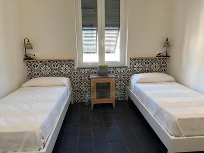Letto o letti in una camera di HH Moneglia la Piazzetta L' Attico