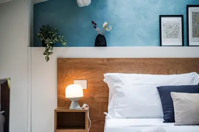 Letto o letti in una camera di Giardini 411 Rooms