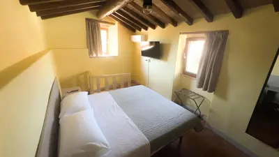 Letto o letti in una camera di Residenze del Borgo