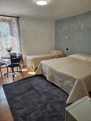 Letto o letti in una camera di Regina Margherita affittacamere