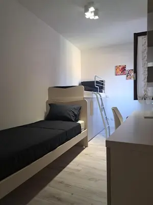 Letto o letti in una camera di L'Aldina - intero appartamento 2 camere ristrutturato Top a 2 passi dal centro