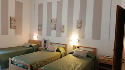 Letto o letti in una camera di Hotel Azzurra