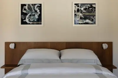 Letto o letti in una camera di Dé Corner Rooms and Suites
