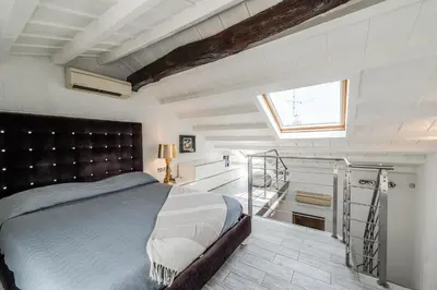 Letto o letti in una camera di Strada Nuova - Eleganza e terrazza vista Duomo