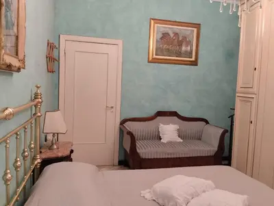 Letto o letti in una camera di Amarcorde Home in Corso Buenos Aires con 6 posti letto