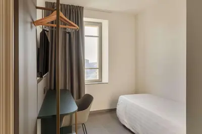 Letto o letti in una camera di B&B HOTEL Piacenza