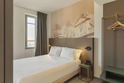 Letto o letti in una camera di B&B HOTEL Piacenza