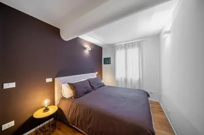 Letto o letti in una camera di Appartamento LAURA - Residenze Estensi