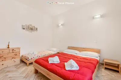 Letto o letti in una camera di La Corte dei ValEmi 1-4, TerreMarine