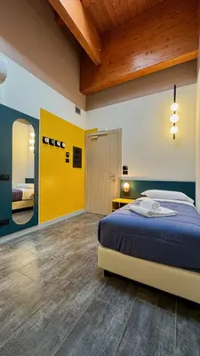 Letto o letti in una camera di HC Hotel Manerbio Loft