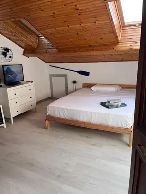Letto o letti in una camera di LA MANSARDINA 