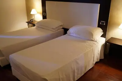 Letto o letti in una camera di Cremona Palace Hotel