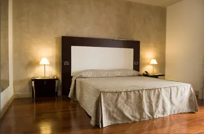 Letto o letti in una camera di Cremona Palace Hotel