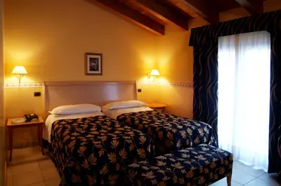 Letto o letti in una camera di Hotel Ristorante Novecento