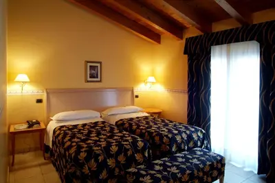 Letto o letti in una camera di Hotel Ristorante Novecento