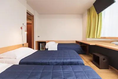 Letto o letti in una camera di Garda Hotel