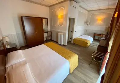 Letto o letti in una camera di Grand Hotel Regina Salsomaggiore