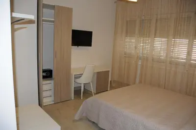 Letto o letti in una camera di Affittacamere La Perla