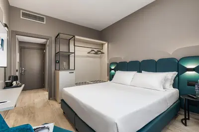 Letto o letti in una camera di City Style Hotel Reggio Emilia