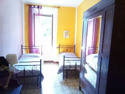 Letto o letti in una camera di Ca Giulietto Antico Casale in Lunigiana