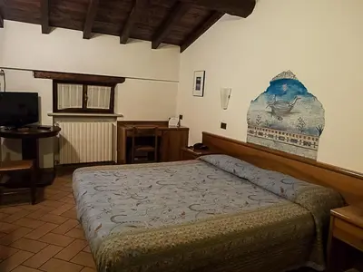 Letto o letti in una camera di Albergo Giulia Gonzaga
