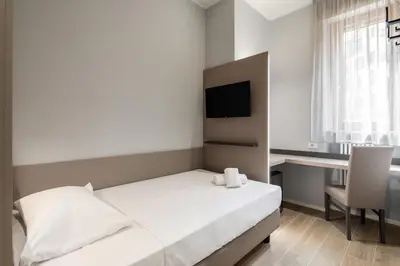 Letto o letti in una camera di Hotel Excelsior Pavia