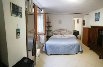 Letto o letti in una camera di APPARTAMENTO CON GIARDINO, TERRAZZO e GARAGE A DUE PASSI DAL MARE e DALLE CINQUETERRE