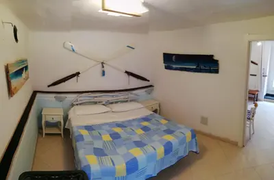 Letto o letti in una camera di APPARTAMENTO CON GIARDINO, TERRAZZO e GARAGE A DUE PASSI DAL MARE e DALLE CINQUETERRE