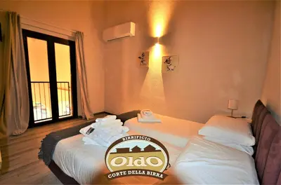 Letto o letti in una camera di CORTE DELLA BIRRA - OLDO